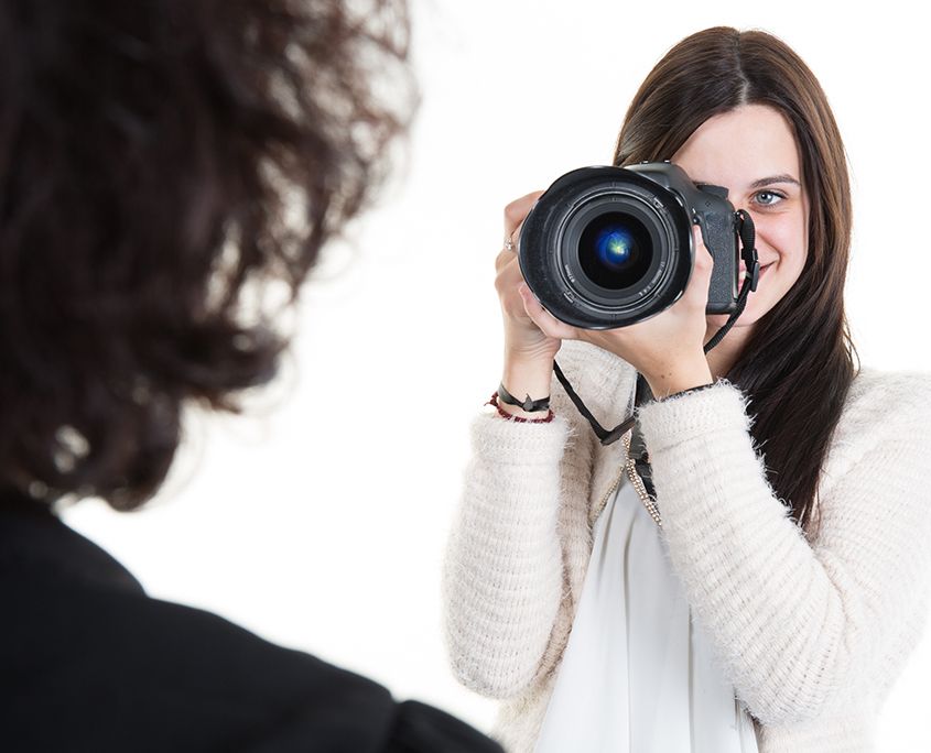 Photographer taking a professional passport photo in our Orlando studio